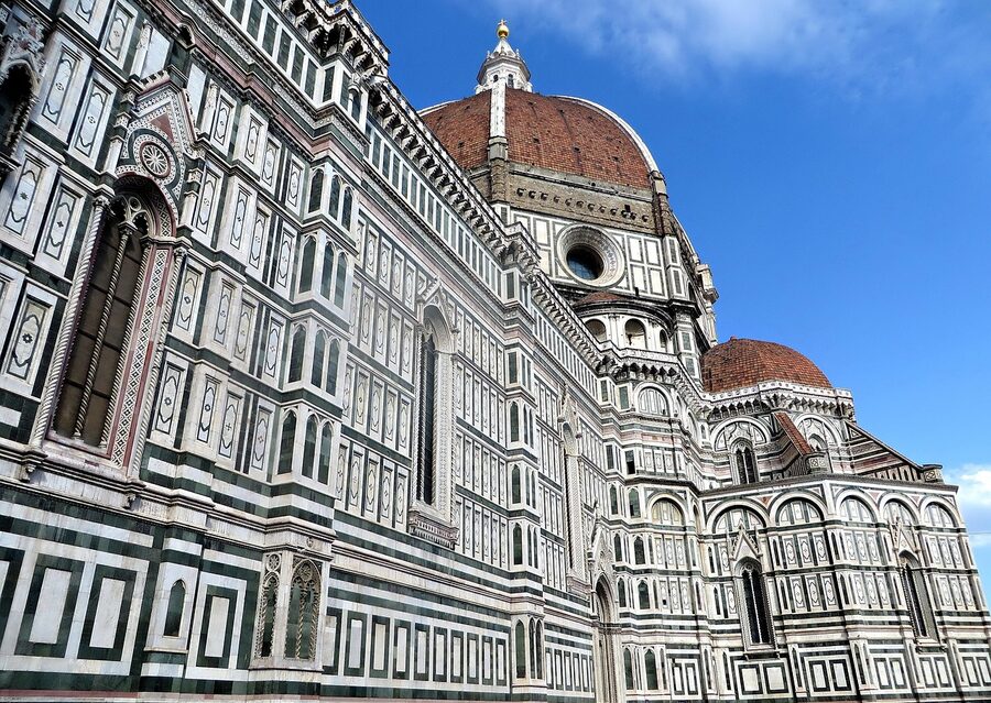 Detailed view of the Florence Cathedral facade with its green and pink marble panels and Gothic architectural details