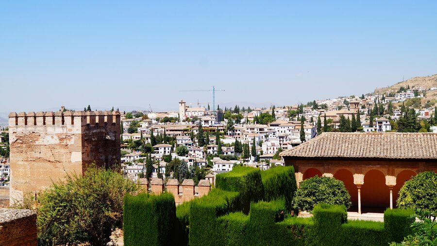 The Alhambra fortress and Albaicin neighbourhood with mountains and greenery in Granada Spain