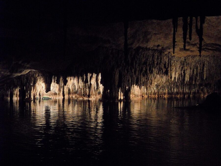 Chamber inside a Mallorca cave with illuminated stalactites and stalagmites