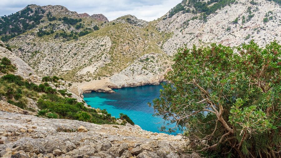 Turquoise waters and rocky coastline of a bay in Mallorca during winter season
