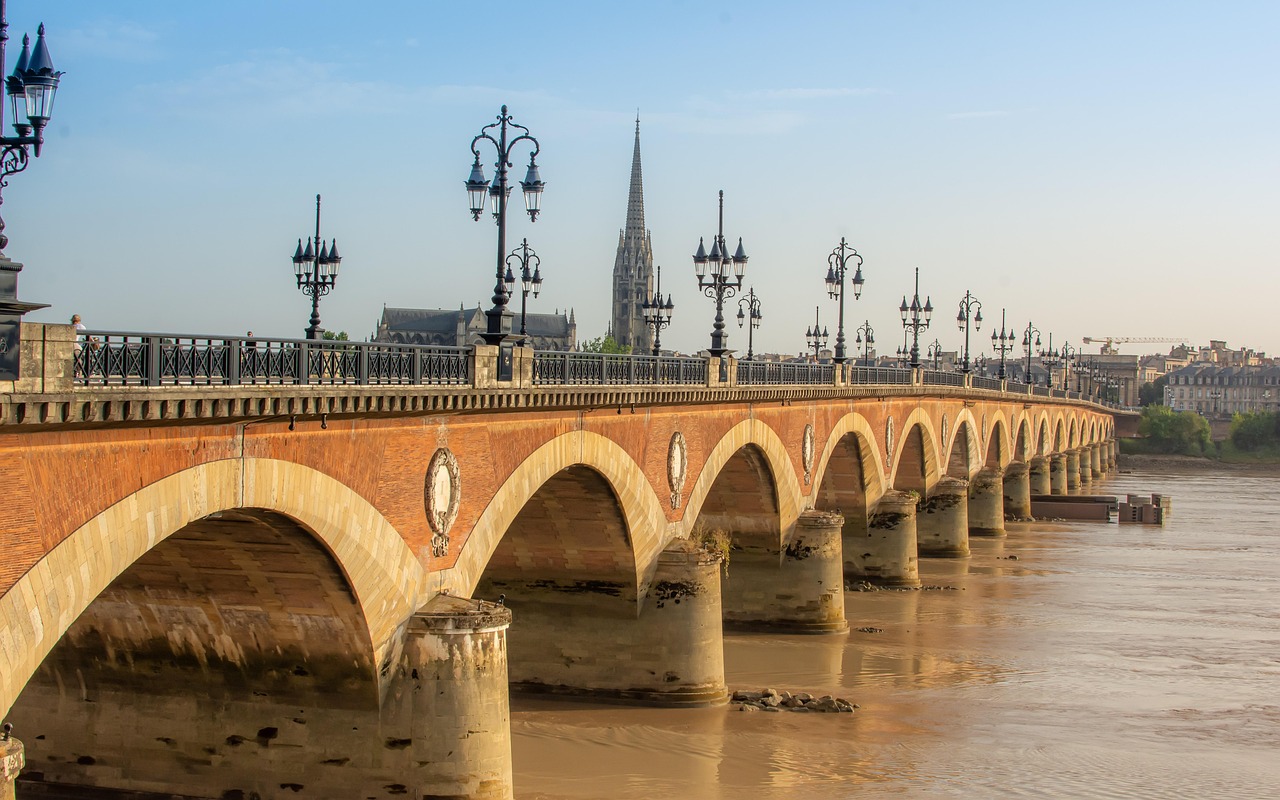 Close view of the stone arches of Pont de Pierre bridge over the Garonne River in Bordeaux