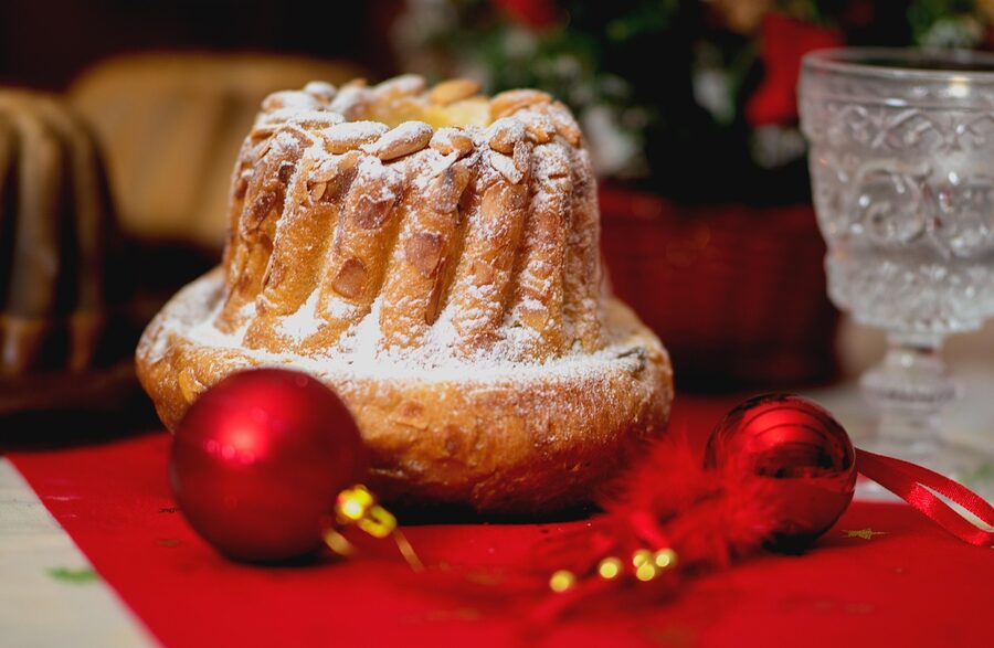 A ring-shaped kougelhopf cake dusted with powdered sugar on a festive surface