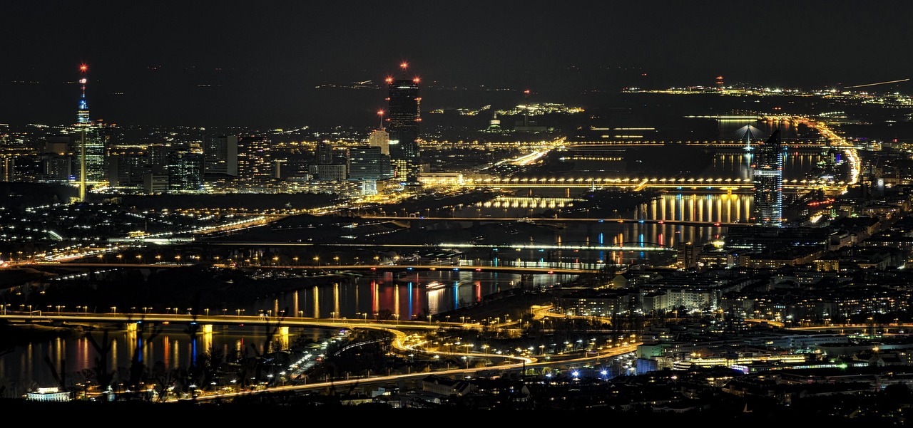 Vienna Danube River at night with illuminated bridges and city lights reflecting on the water