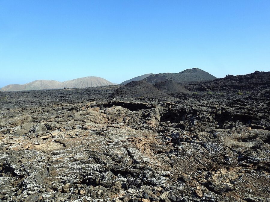 Expansive lava field at Timanfaya with textured black volcanic rock in Lanzarote