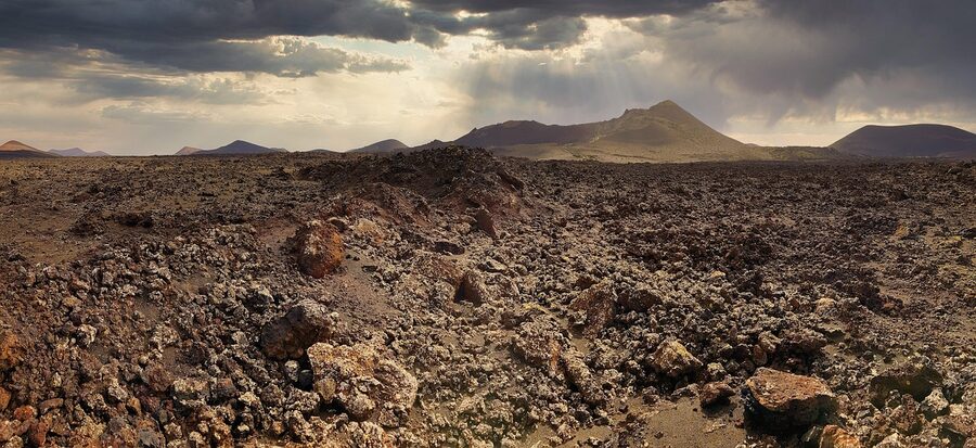 Moon-like volcanic landscape with barren lava formations in Lanzarote