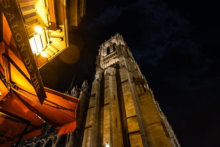 Cafe and salon de the near Notre Dame Cathedral in Paris at night