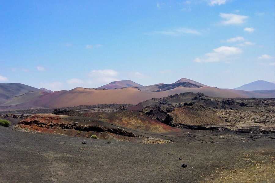 Arid volcanic landscape at Timanfaya with sparse vegetation in Lanzarote
