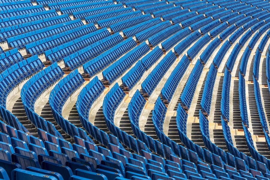 Football stadium seats and pitch viewed from upper tier