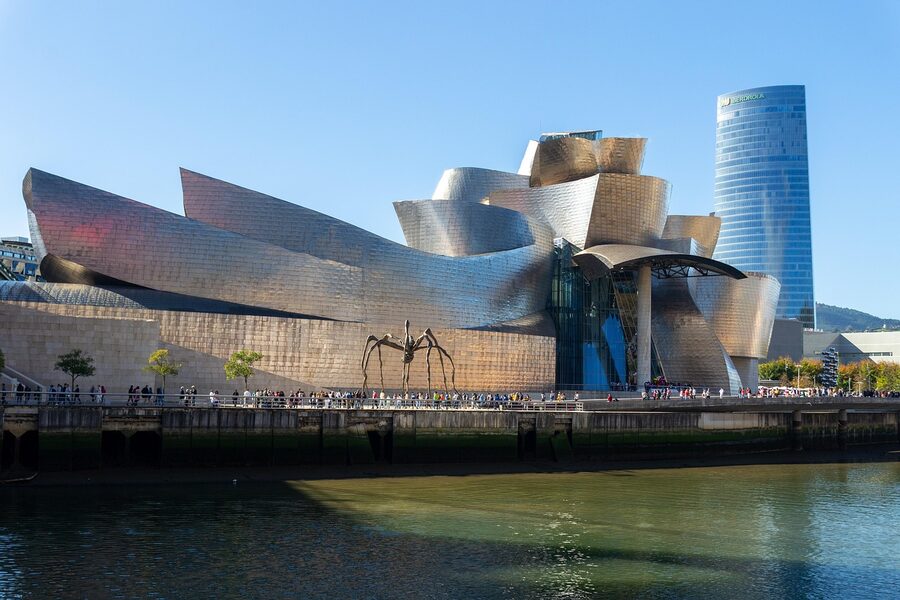 Historic buildings of Bilbao old town reflected in the calm waters of the Nervion river