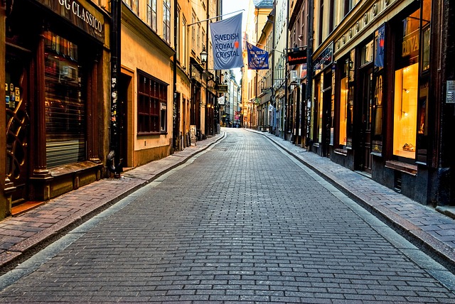 Empty cobblestone street with shops in Stockholm Old Town early morning