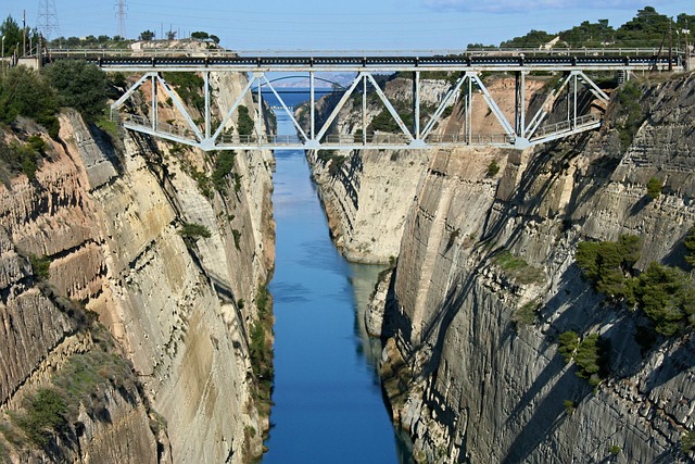 Looking down into the deep Corinth Canal from the bridge showing steep limestone walls