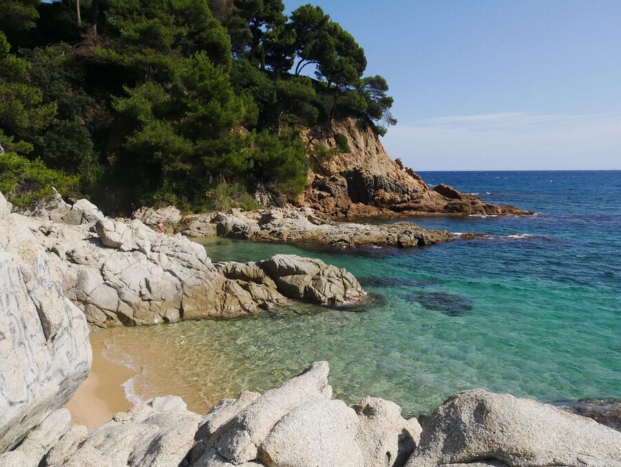 The seaside town of Calella de Palafrugell seen from the Mediterranean with fishing boats in the foreground