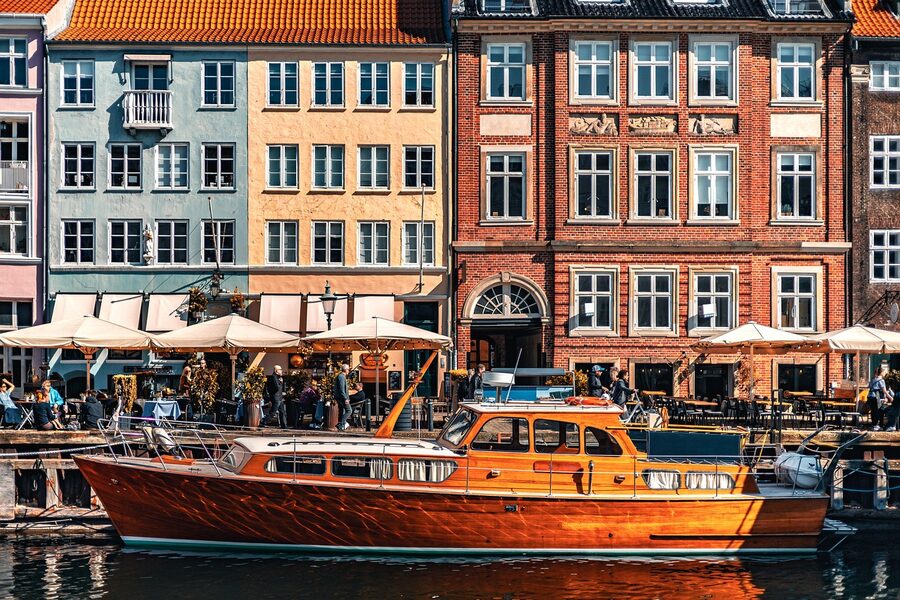 Colorful houses and boats along Nyhavn canal Copenhagen