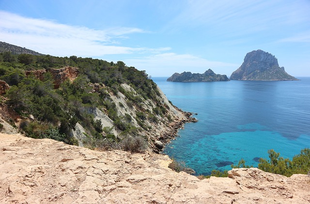 Es Vedra dramatic rock formation rising from Mediterranean Sea seen from Ibiza coast