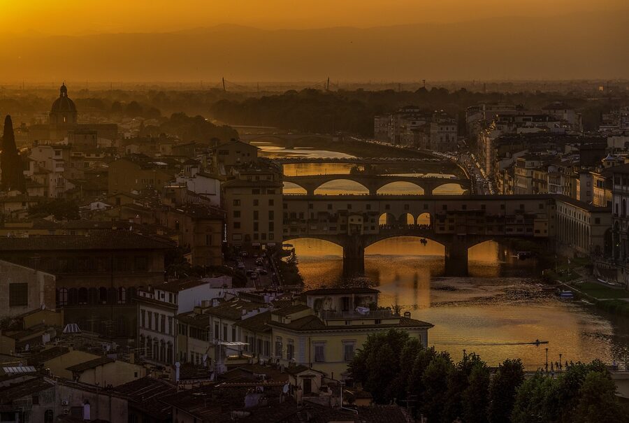 Golden sunset over Florence with the Arno River and Ponte Vecchio bridge in view