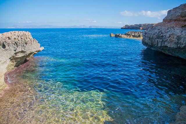 Rocky cala cove in Formentera with clear turquoise sea water