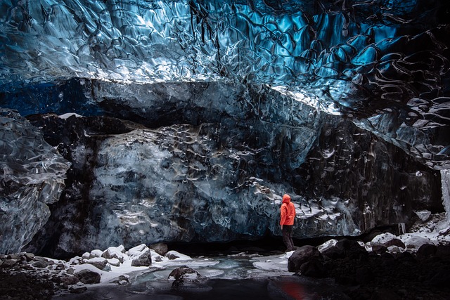 Person standing inside a glacier ice cave in Iceland