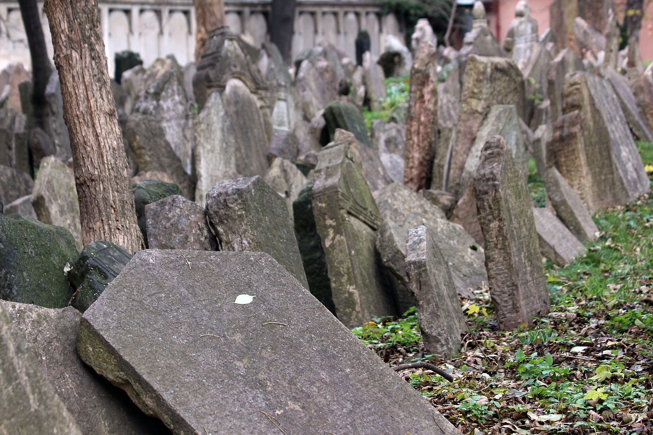 Ancient tombstones in the Prague Jewish Cemetery surrounded by fallen leaves