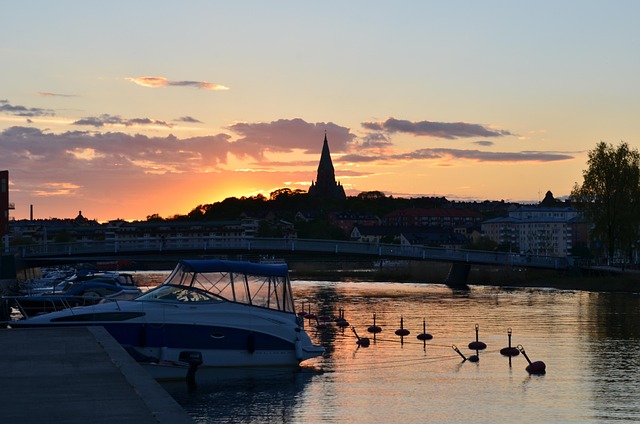 Stockholm bridge with Old Town buildings and church tower at sunset