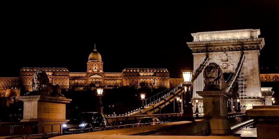 Szechenyi Chain Bridge at dusk with Buda Castle illuminated on the hill behind