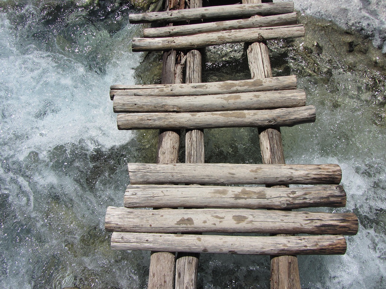 A wooden hiking bridge crossing a stream inside Samaria Gorge in Crete Greece