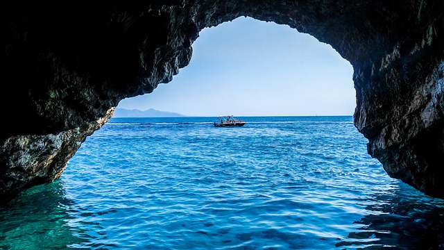 Small boat entering one of the Blue Caves on the northern tip of Zakynthos