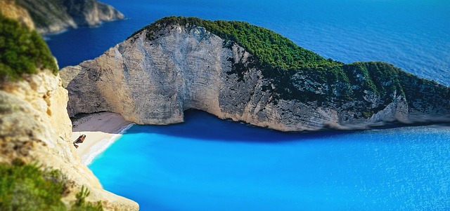Navagio Beach bathed in golden sunset light from the clifftop viewpoint