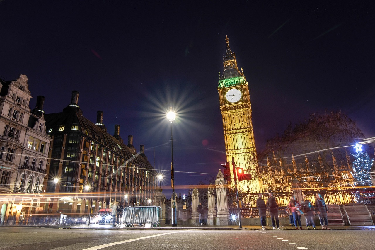Close-up of the Big Ben clock face illuminated at night against a dark sky