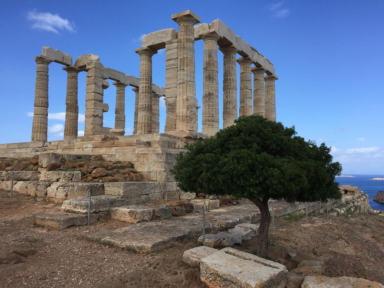Ancient Temple of Poseidon with Doric columns overlooking the Aegean Sea at Cape Sounion