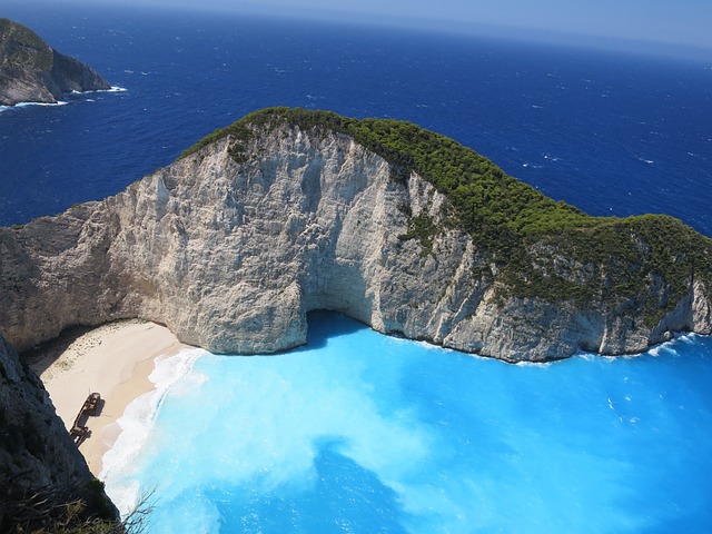 Turquoise bay of Navagio Shipwreck Beach Zakynthos with boats and white sand
