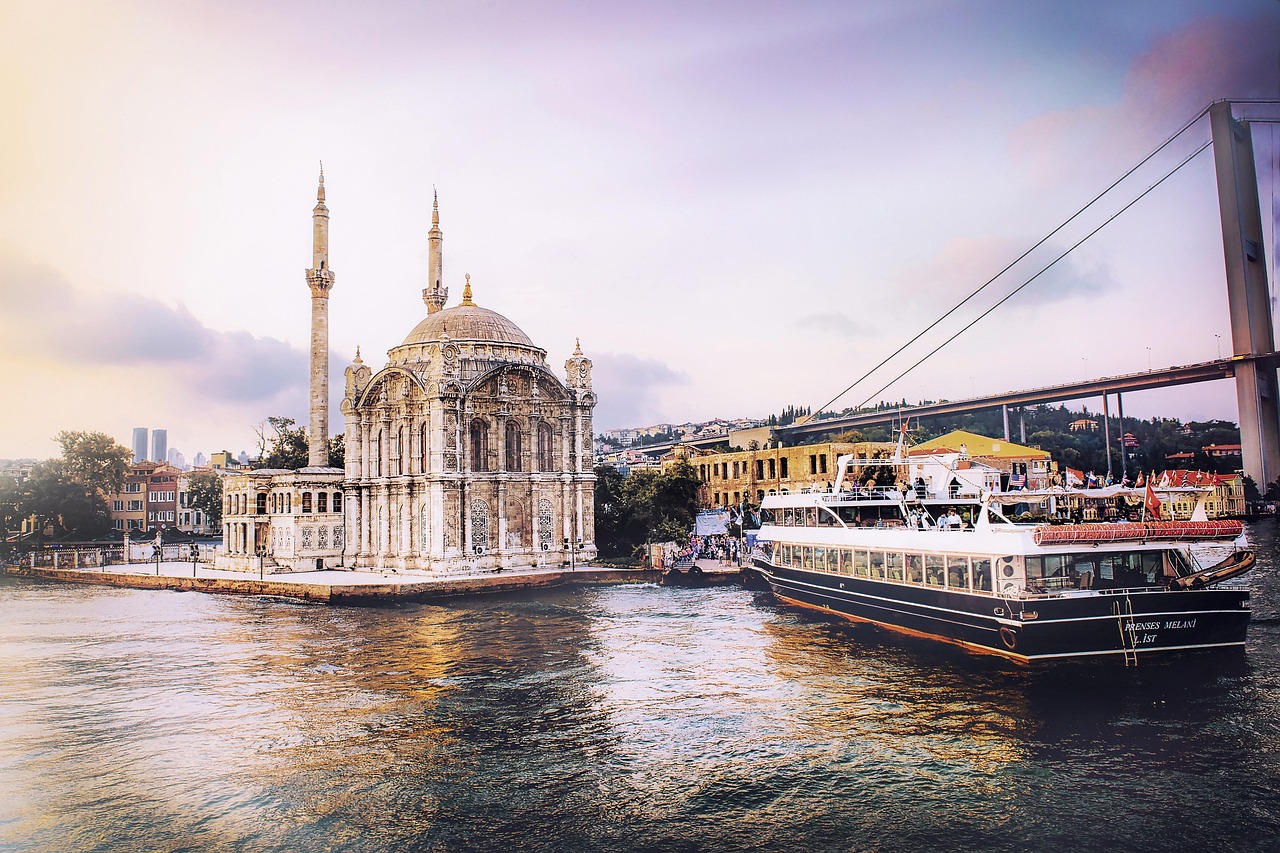 Istanbul city skyline and mosques reflected in the Bosphorus waterway at dusk