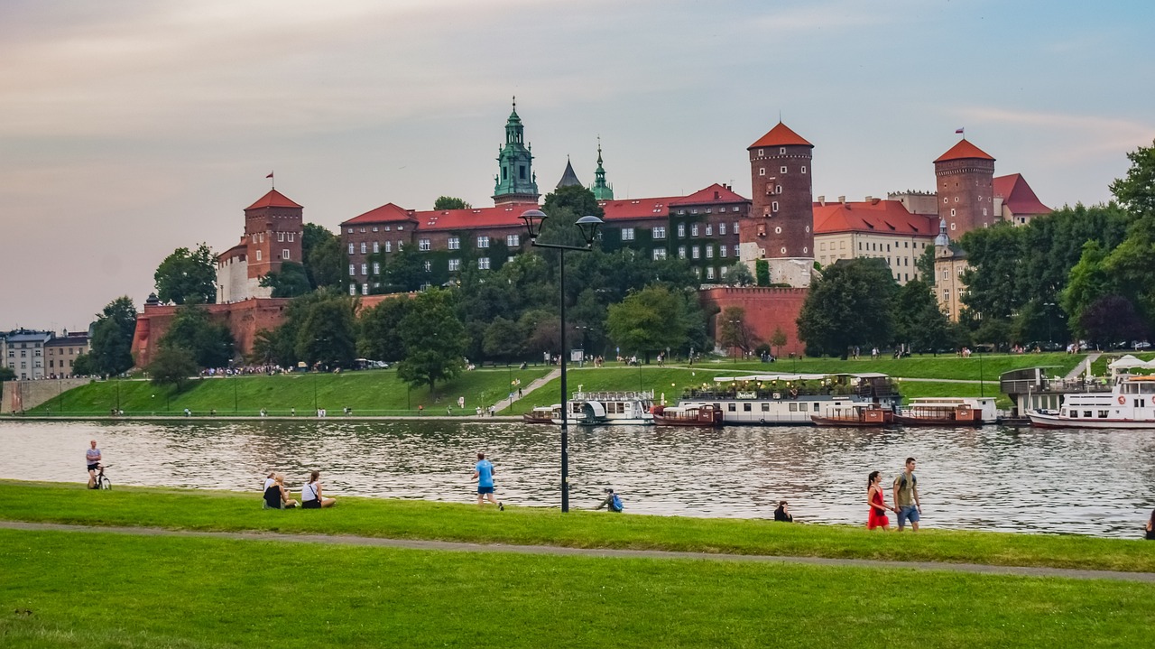 Wawel Castle and surrounding park viewed from across the Vistula River on a summer afternoon
