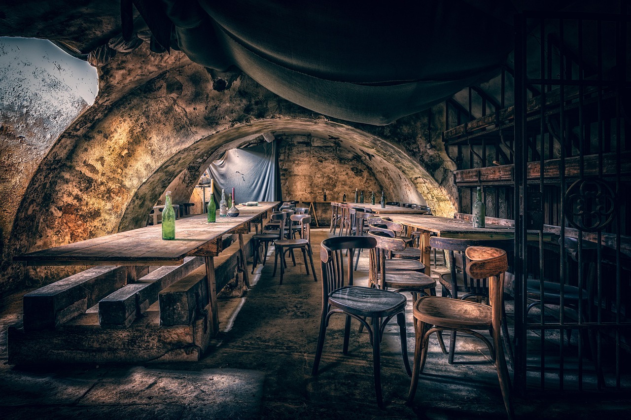 Vaulted stone basement with tables and chairs in old masonry cellar