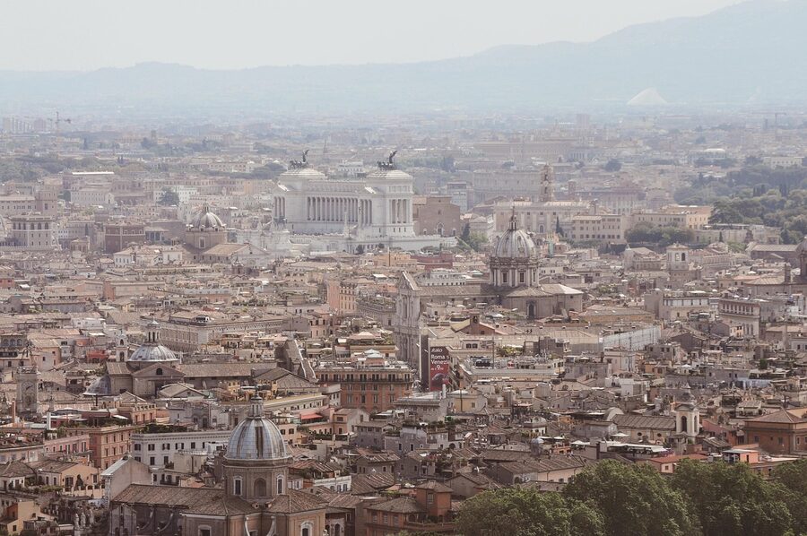 Panoramic view of Rome cityscape with historic domes and buildings shrouded in morning mist