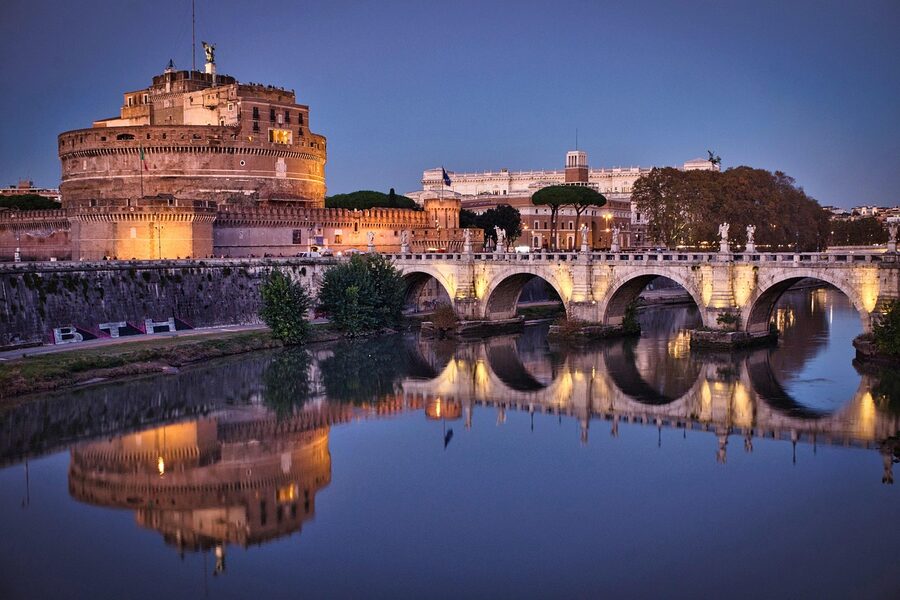 Castel Sant'Angelo in Rome reflected in the Tiber River at blue hour with soft evening light