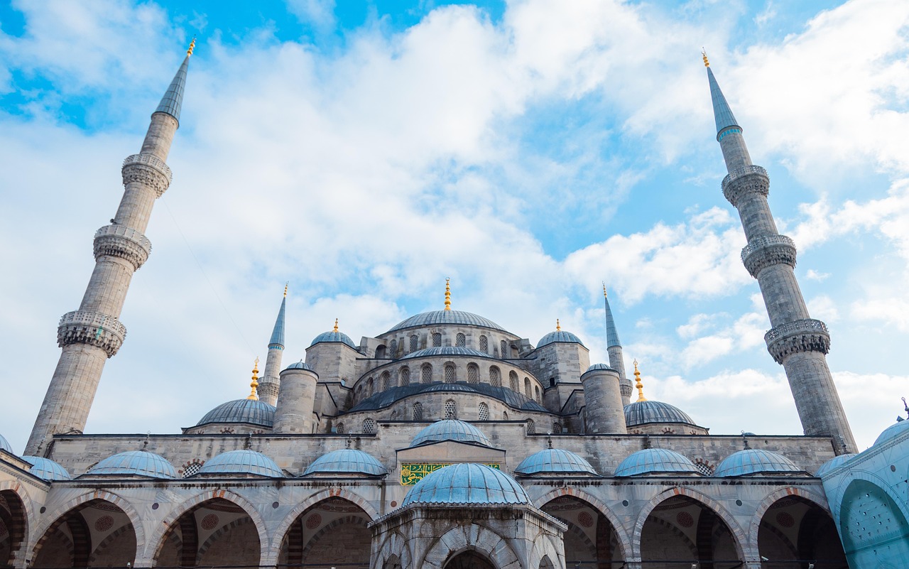 Blue Mosque exterior with its six minarets and cascading domes against a blue sky