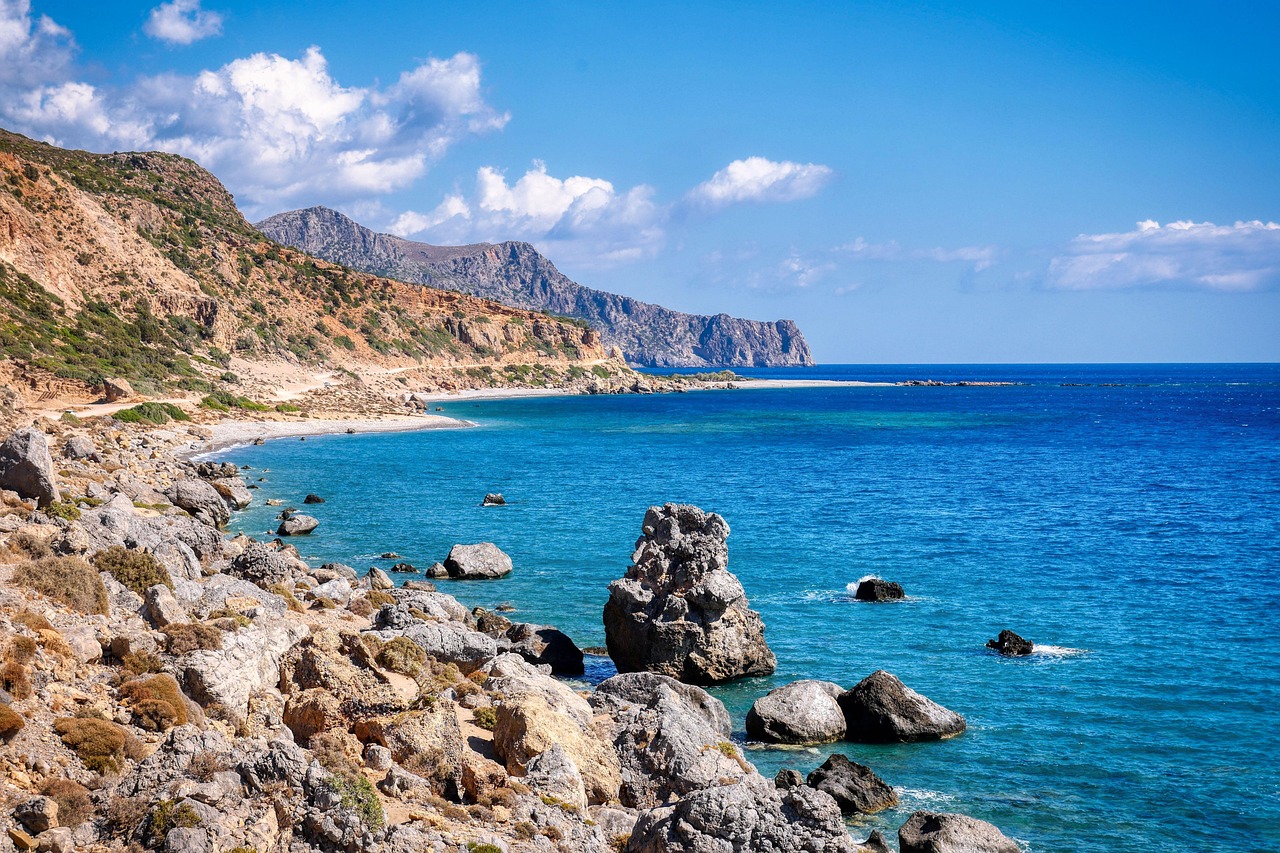 Mountains meeting the sea along the coast of Crete Greece with a rocky beach