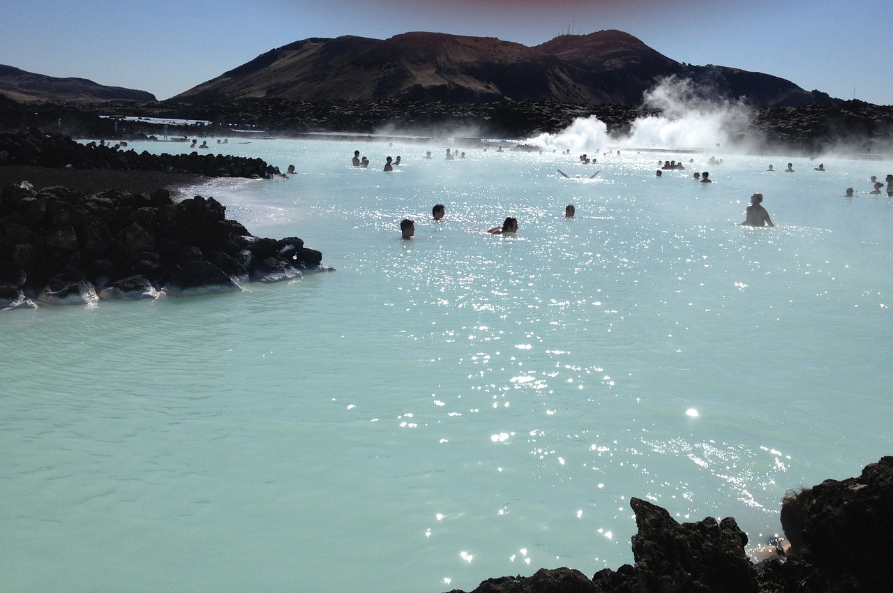 Steaming turquoise waters of the Blue Lagoon in Iceland surrounded by lava rocks
