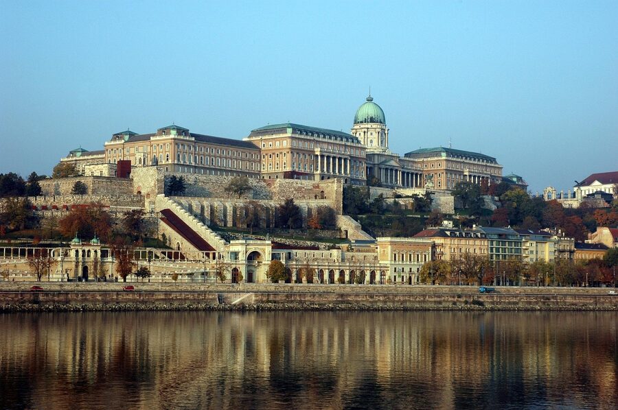 Buda Castle on the hilltop with Pest cityscape viewed from the Danube River in Budapest