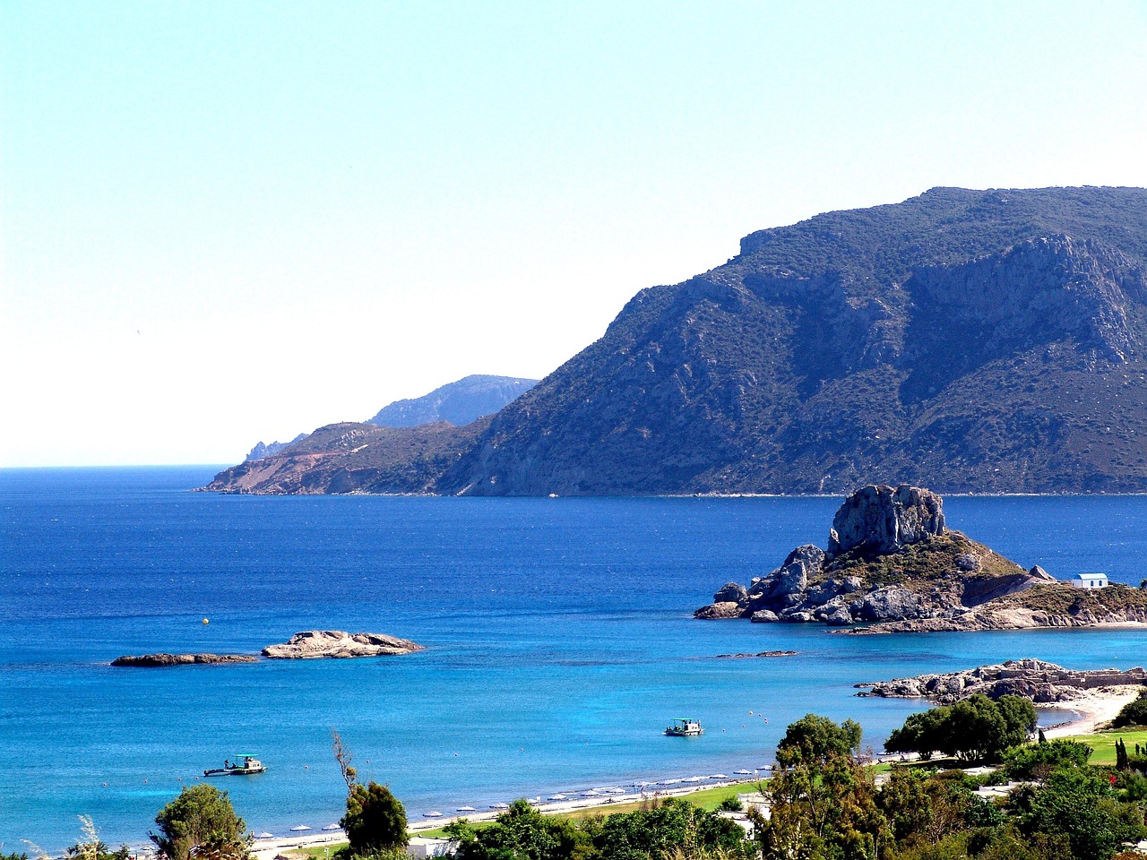 A panoramic view of Kos harbor with boats and the Aegean Sea