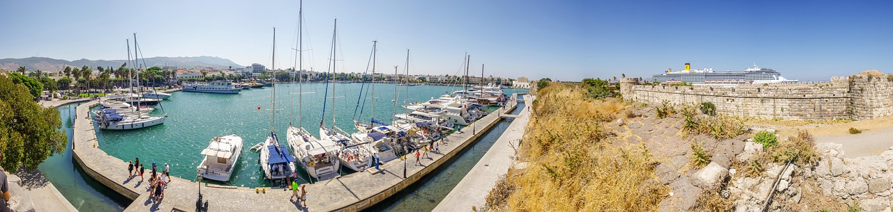 Boats moored in the harbor of Kos with the Aegean Sea stretching to the horizon
