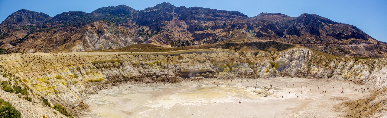 White houses with colorful rooftops in a Nisyros village overlooking the sea