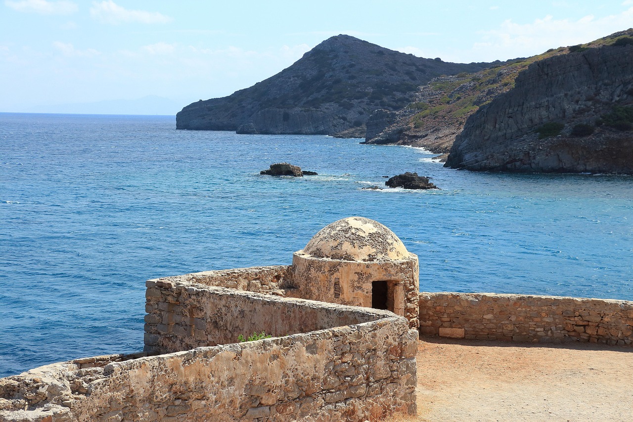 Interior ruins of buildings inside Spinalonga Island showing weathered stone walls and archways