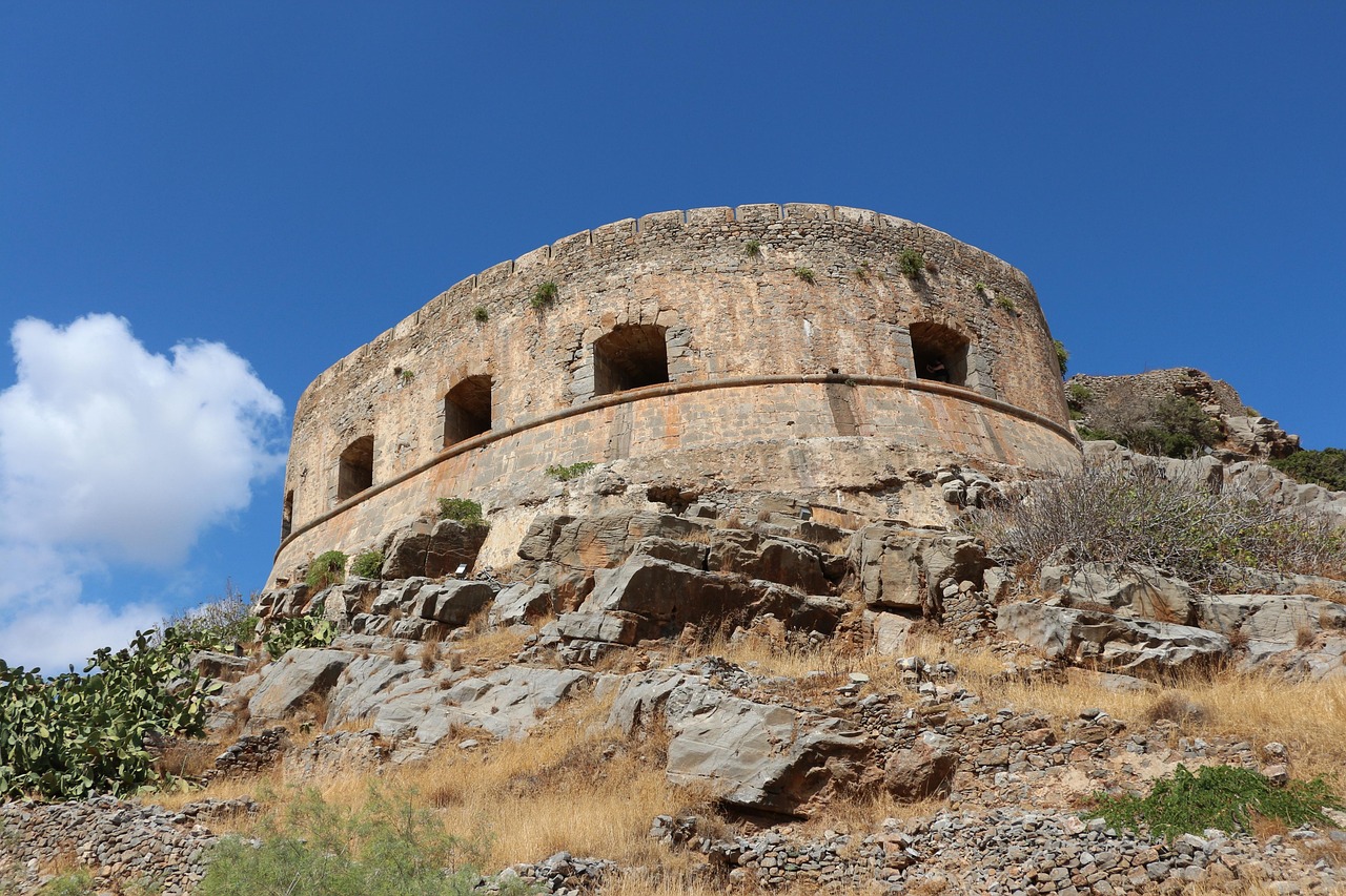 Close view of Spinalonga Island showing the fortified walls and abandoned buildings