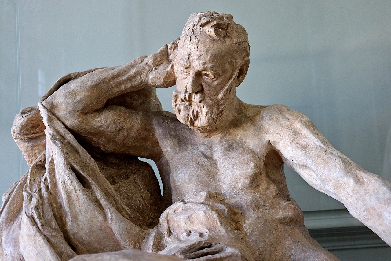 Realistic stone portrait bust by Auguste Rodin of an elderly man