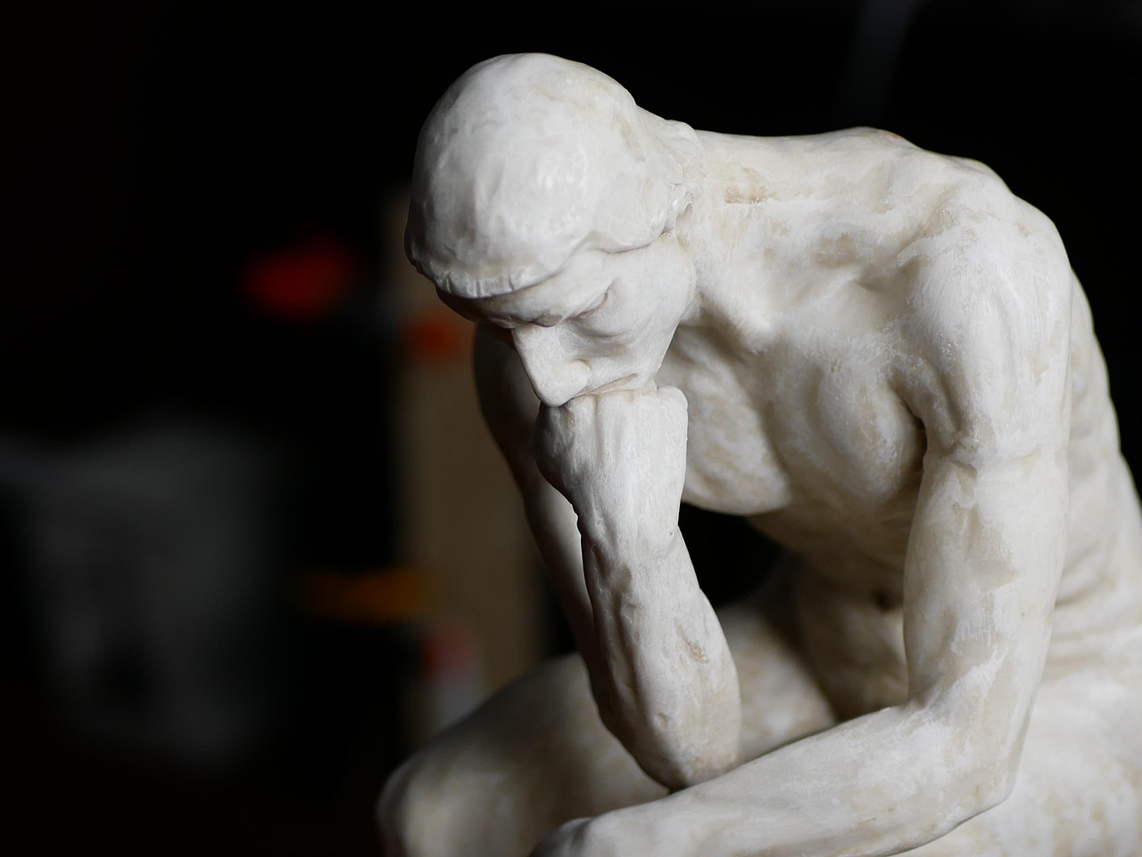 The Thinker sculpture by Rodin in deep contemplation