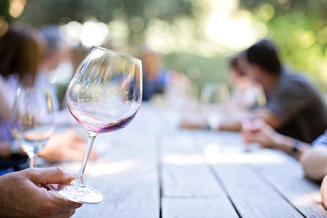 Wine glass being held outdoors with a natural backdrop