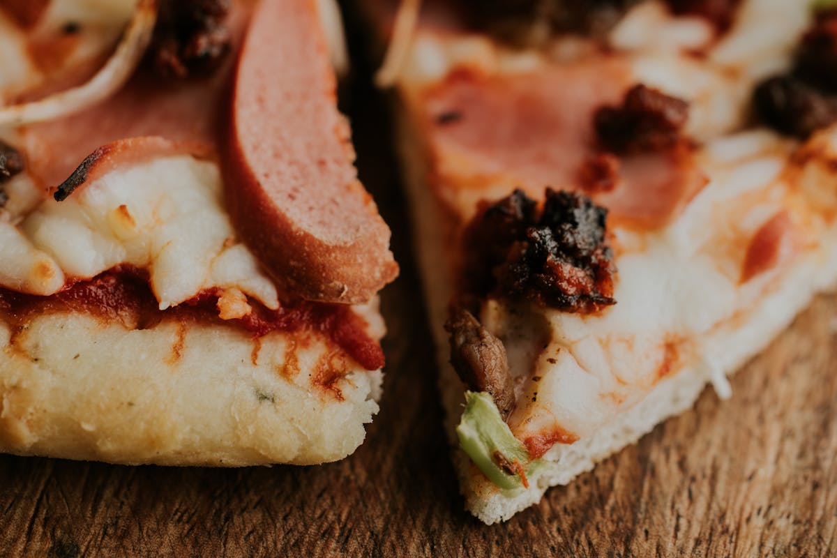 Close-up of a pizza slice being served