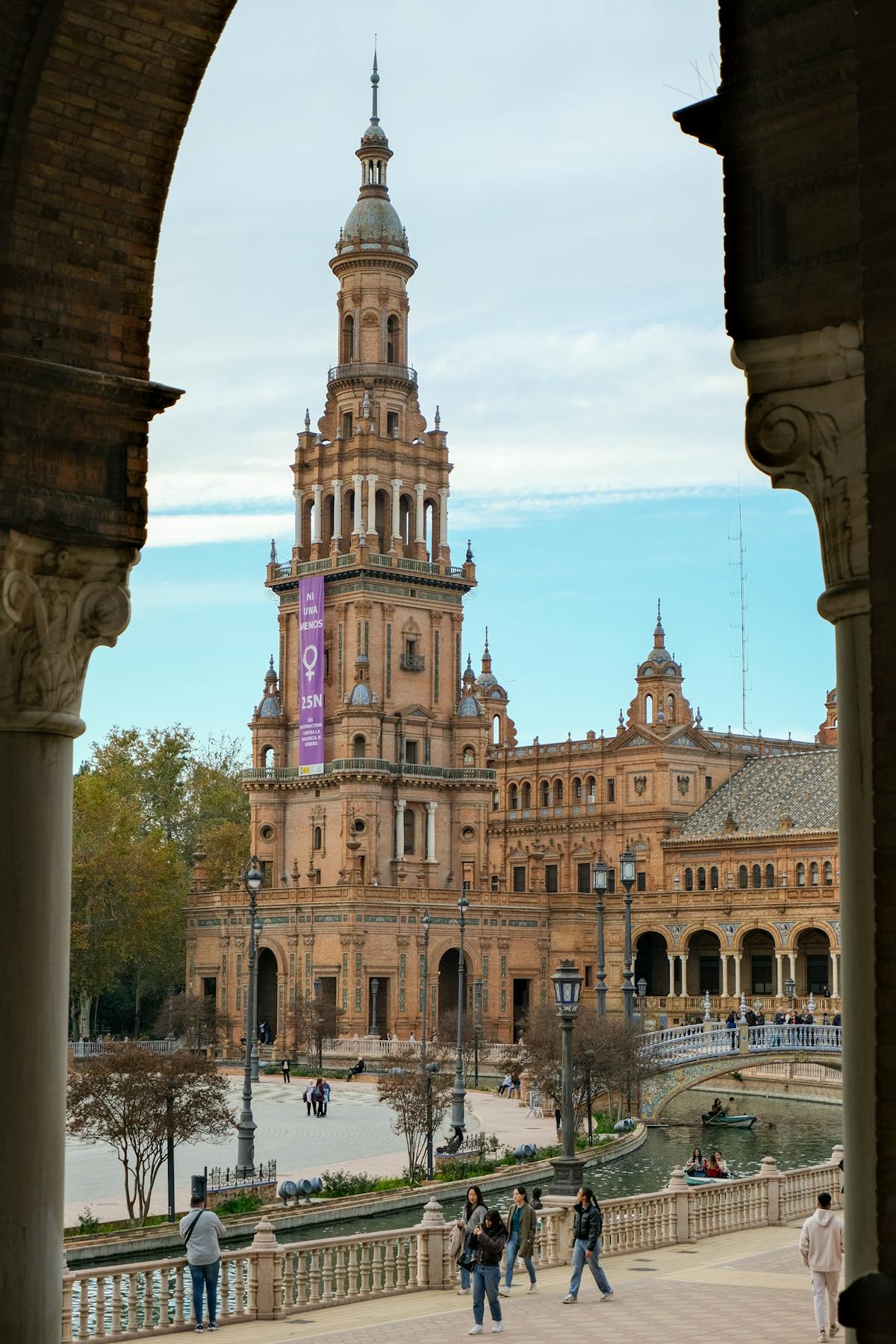 A view of Plaza de Espana in Seville through an archway showcasing the ornate architecture