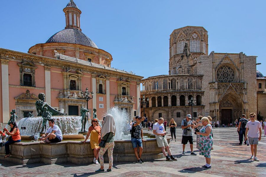Tourists at Plaza de la Virgen in Valencia with cathedral in background